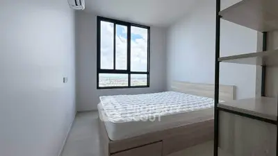 Modern minimalist bedroom with large window and scenic view