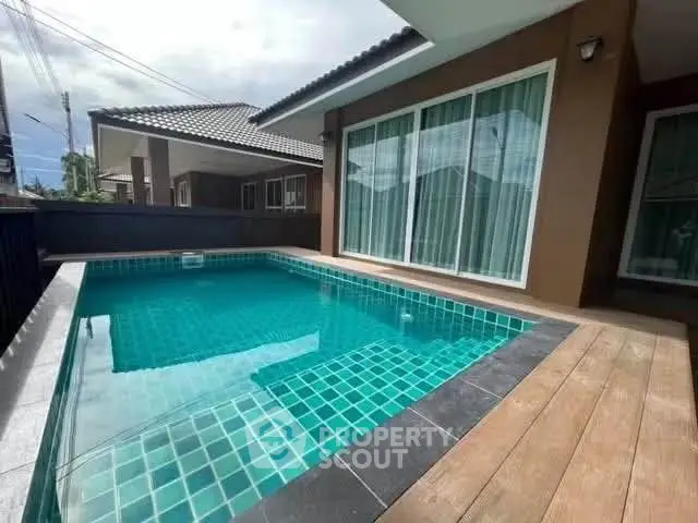 Charming private pool area with modern design and wooden deck, perfect for relaxation and entertainment.