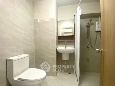 Modern bathroom with sleek fixtures and neutral tiles