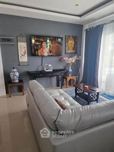Elegant living room with modern decor and wall-mounted TV