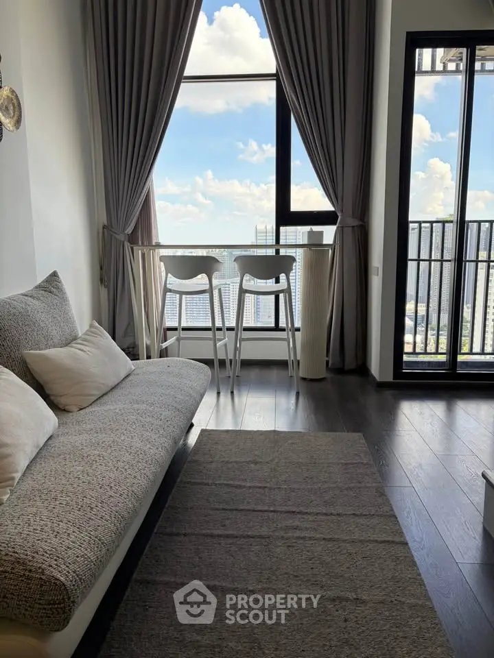 Modern living room with stunning city view and balcony access