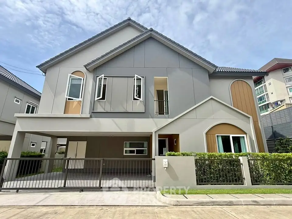 Modern two-story house with stylish facade and spacious driveway in a suburban neighborhood.