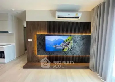 Modern living room with stylish TV wall and air conditioning unit.