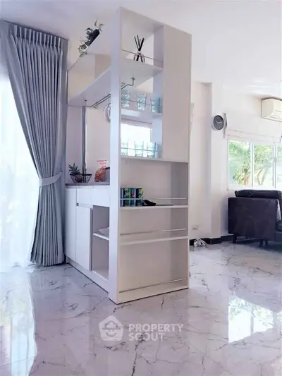 Modern living room with marble floors and stylish shelving unit