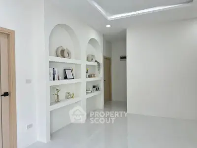 Minimalist living room with built-in shelves and modern decor