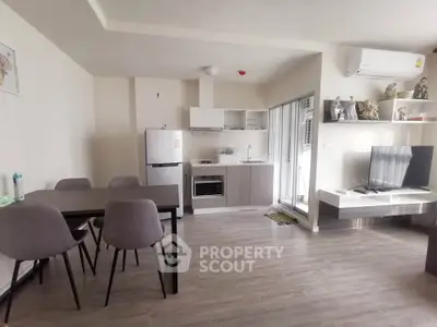 Modern open-layout kitchen and living room with dining area and TV setup
