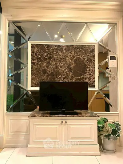 Luxurious living room with elegant marble accents and modern TV setup