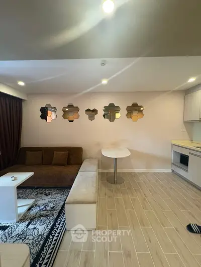 Modern living room with stylish mirrors and cozy seating area in a contemporary apartment.