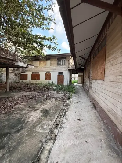 Explore potential in this fixer-upper property with spacious outdoor area and rustic charm.