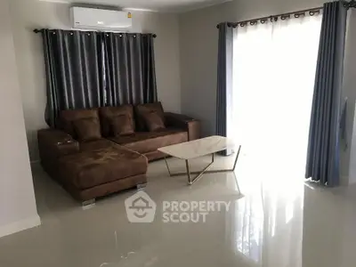 Modern living room with brown sofa and elegant curtains