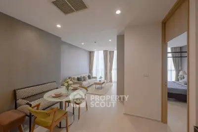 Modern open-plan living and dining area with stylish decor and natural light.