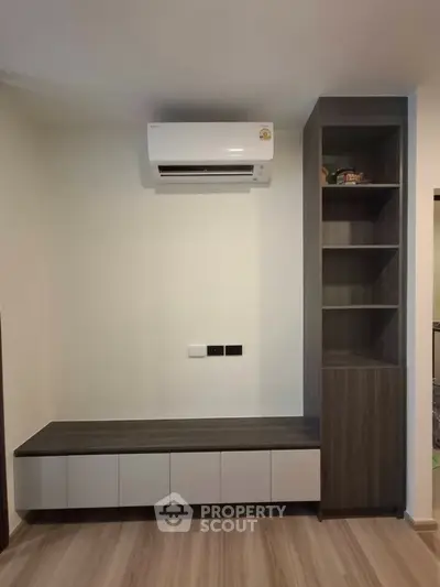 Modern interior with built-in shelving and air conditioning unit, perfect for stylish living room setup.