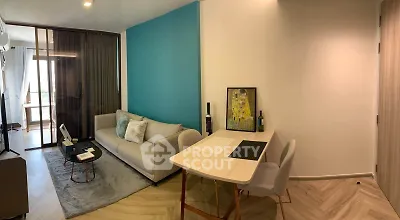 Modern living room with stylish decor and cozy seating area, featuring a vibrant accent wall and elegant furnishings.