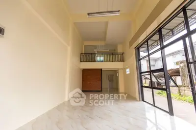 Spacious open-plan interior with high ceilings and large windows