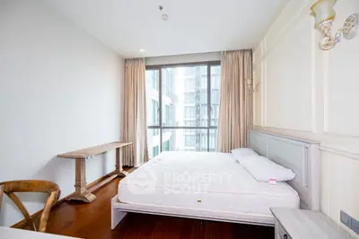 Bright and airy bedroom with large window and elegant furnishings in modern apartment.
