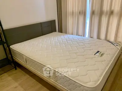Spacious bedroom with a comfortable queen-sized bed and elegant curtains, perfect for restful nights.