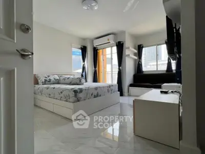 Modern bedroom with sleek design, large windows, and city view, featuring stylish furniture and natural light.