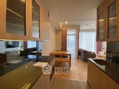 Modern open-plan kitchen and living room with sleek design and natural light