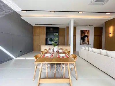 Modern open-plan living and dining area with sleek design and natural light