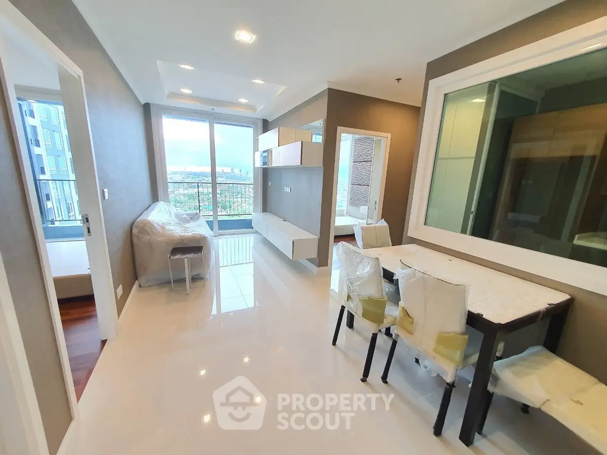 Modern living room with balcony and city view in high-rise apartment