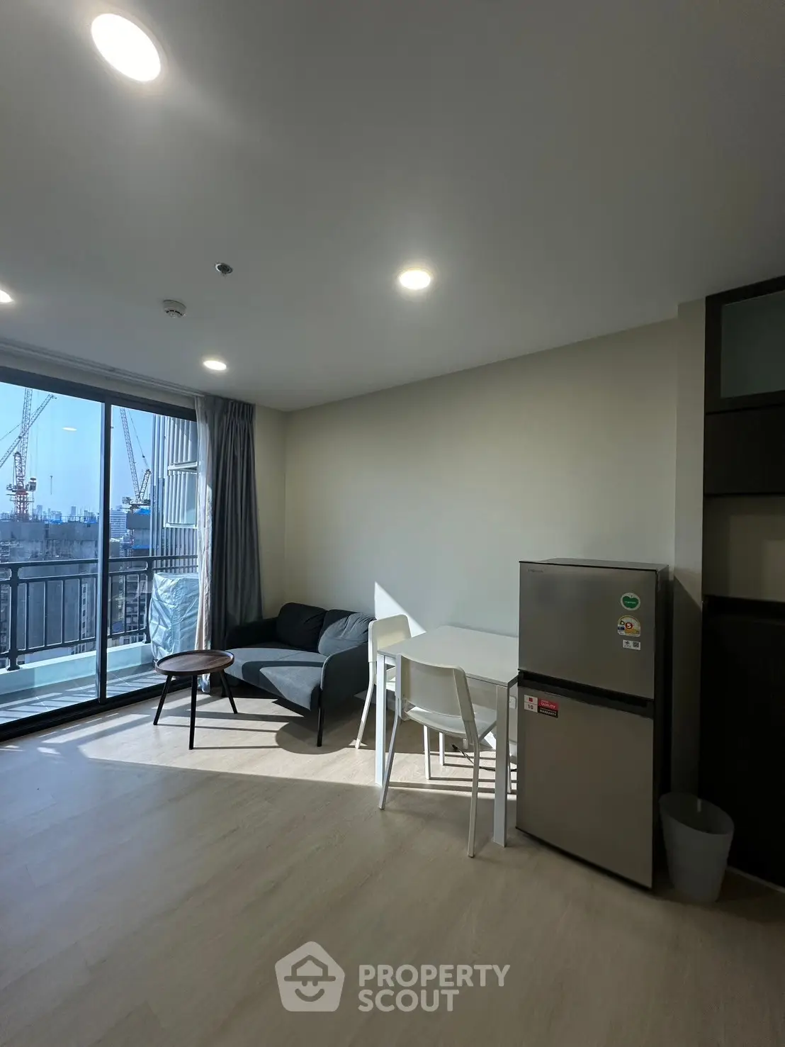 Modern apartment living room with balcony and city view