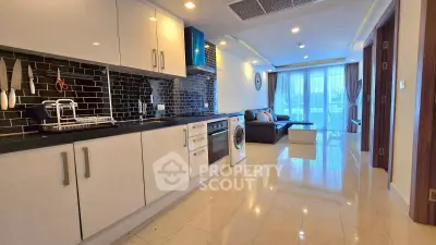 Modern open-plan kitchen and living room with sleek design and natural light.