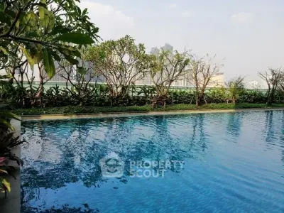 Luxurious outdoor pool with lush greenery and serene ambiance