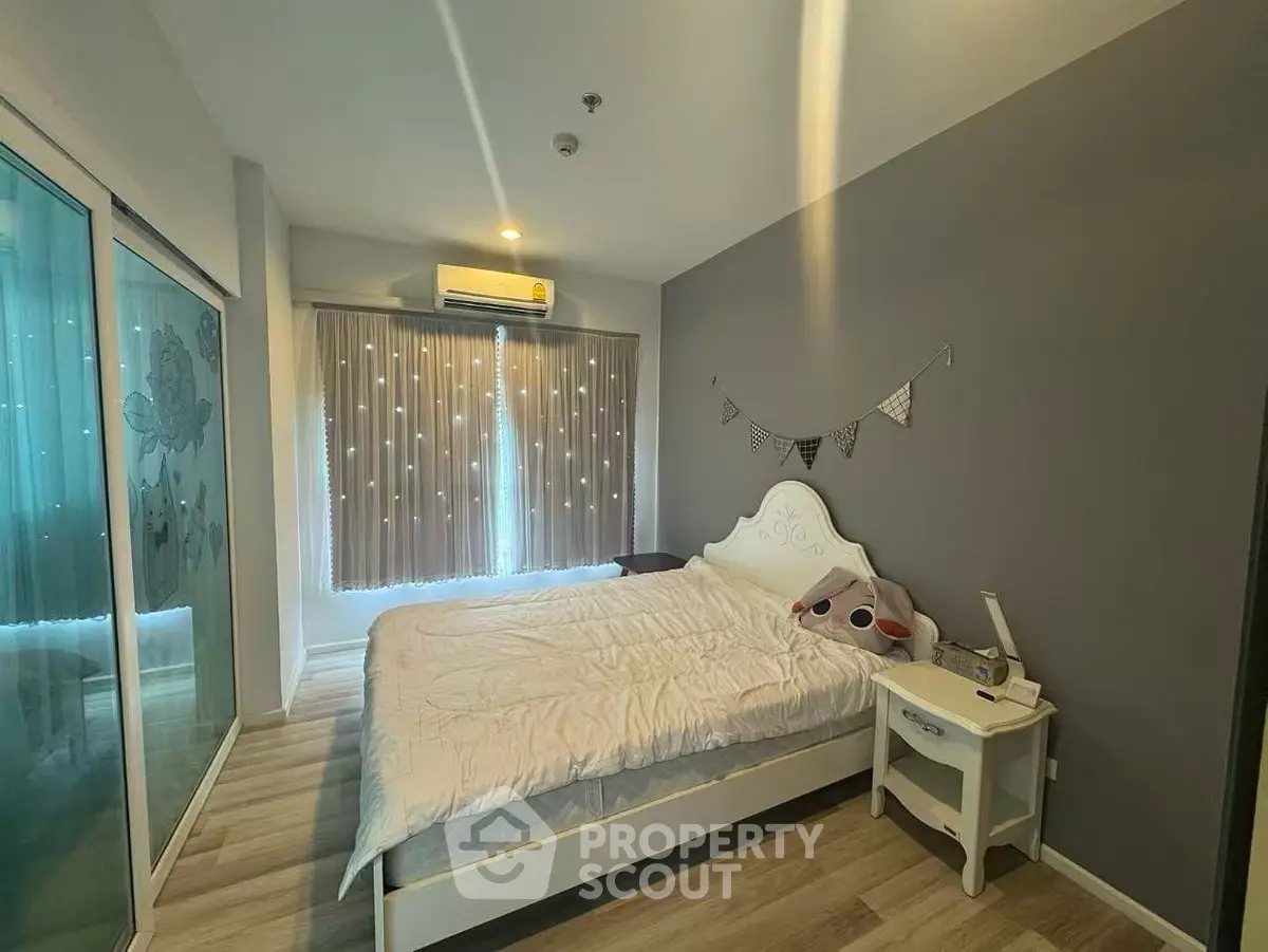 Cozy bedroom with stylish decor and ample natural light