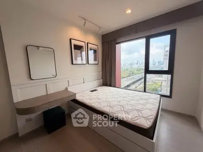 Modern bedroom with city view, featuring a large window and stylish decor.