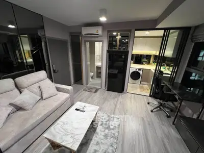 Modern living room with sleek design, open kitchen, and stylish furniture in a contemporary apartment.