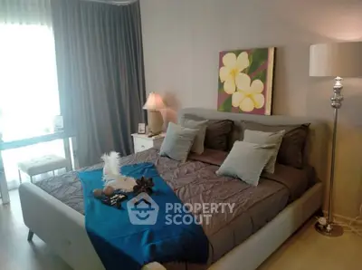 Elegant bedroom with modern decor and natural light, featuring a cozy bed and stylish furnishings.