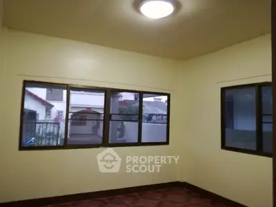 Spacious room with large windows and tiled flooring, ideal for customization.