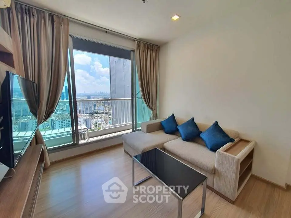 Modern living room with city view, featuring a cozy sofa and sleek decor.