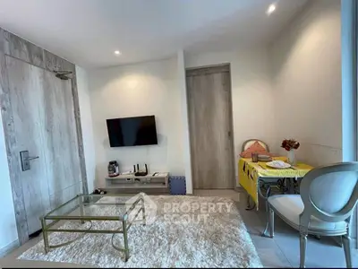 Modern living room with stylish decor and cozy ambiance, featuring a plush rug and elegant furniture.