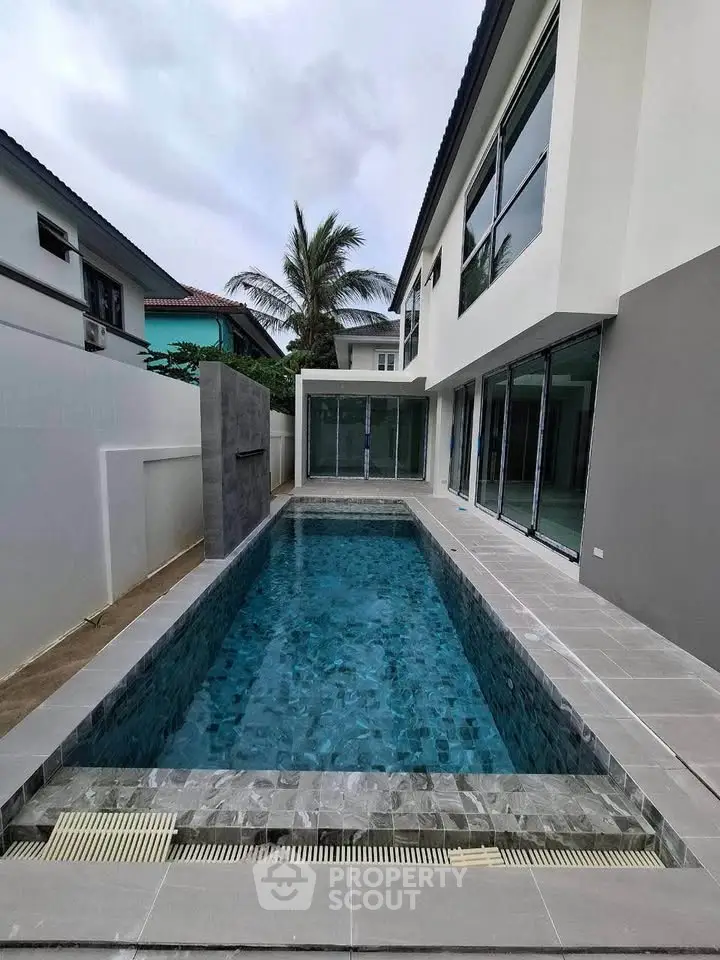 Modern home with sleek private pool and spacious patio area, perfect for relaxation and entertainment.