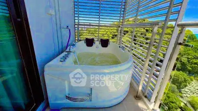 Luxurious balcony with outdoor bathtub and scenic view, perfect for relaxation.