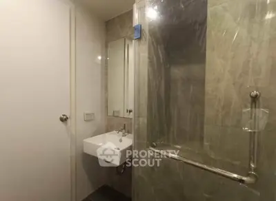 Modern bathroom with sleek sink and glass shower enclosure