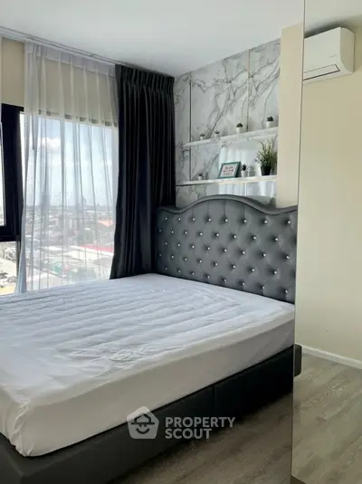Modern bedroom with tufted headboard and large window view