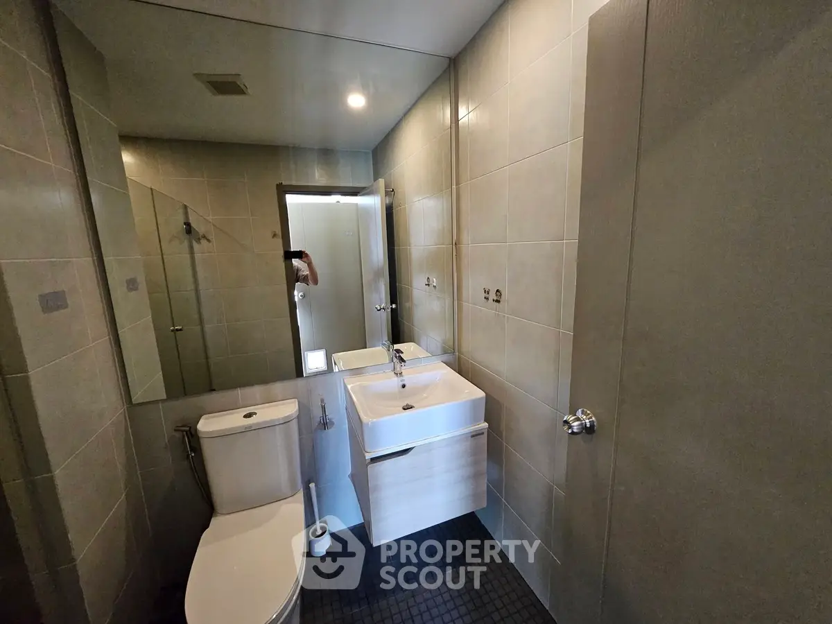 Modern bathroom with sleek fixtures and large mirror