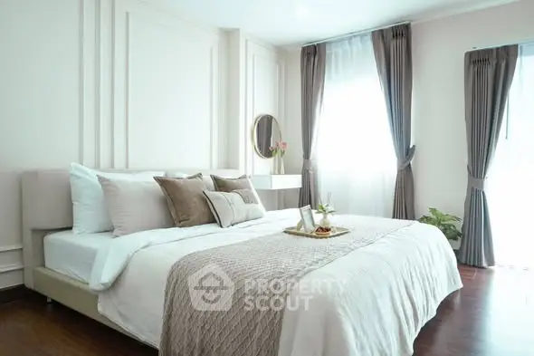 Elegant bedroom with natural light, stylish decor, and cozy ambiance perfect for relaxation.