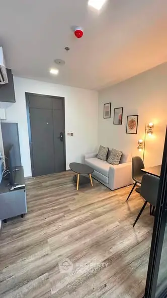 Modern living room with stylish decor and wooden flooring in a contemporary apartment.