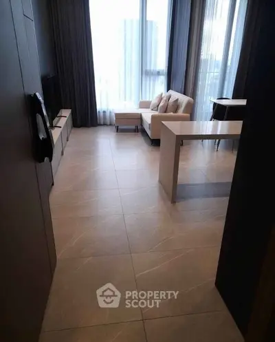 Modern living room with sleek tile flooring and stylish furniture in a high-rise apartment.