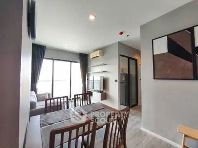 Modern living room with dining area and balcony view in stylish apartment