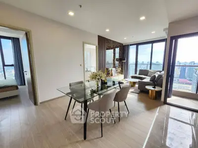 Modern open-plan living room with city view and elegant dining area