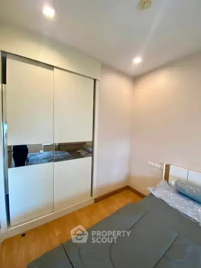 Cozy bedroom with modern wardrobe and soft lighting, perfect for restful nights.