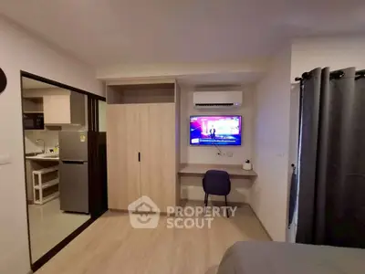 Modern studio apartment with sleek design and built-in storage solutions.