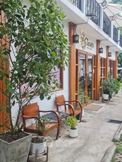 Charming exterior view of a cozy cafe with wooden accents and outdoor seating.