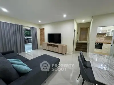 Modern living room with sleek furniture and open kitchen layout