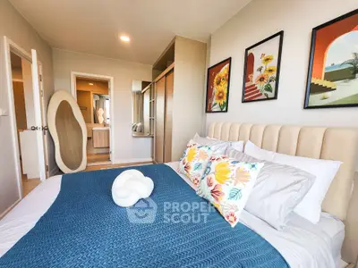 Stylish bedroom with modern decor and vibrant artwork, featuring a cozy bed and ample storage space.