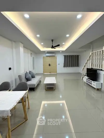 Spacious modern living room with sleek design and elegant lighting, perfect for family gatherings.